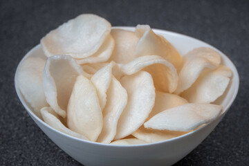 Cooked rice chips in bowl - Grey background