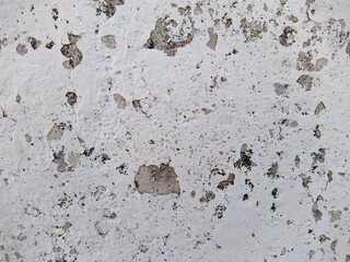 old and white concrete wall with which paint peels off.