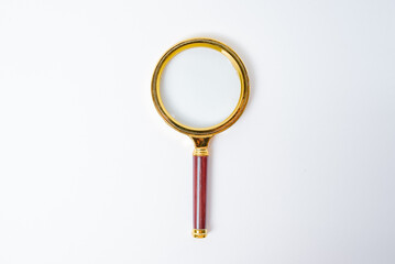 golden magnifying glass isolated on white background with copy space