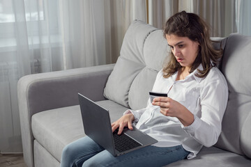 Young disabled woman with organic damage of central nervous system enters bank credit card details...