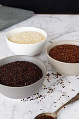 Quinoa of different colors: white, red and black in a bowl. Healthly gluten free grains.