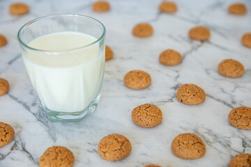 Amaretti cookies and glass of milk drink. Small soft Italian traditional sweet-bitter pastry...