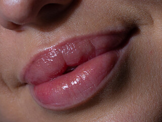 Sexual full lips. Natural gloss of lips and woman's skin. The mouth is closed. Increase in lips, cosmetology. Natural lips. Great summer mood with open eyes. fashion jewelry. Pink lip gloss
