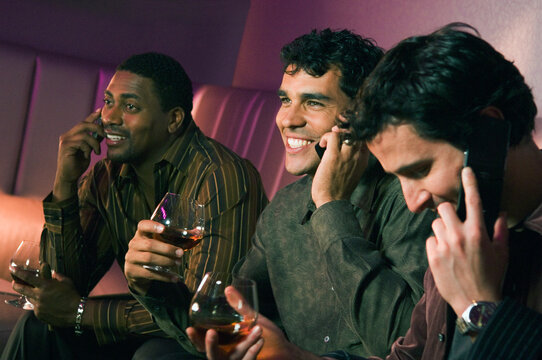 Multi-ethnic men talking on cell phones