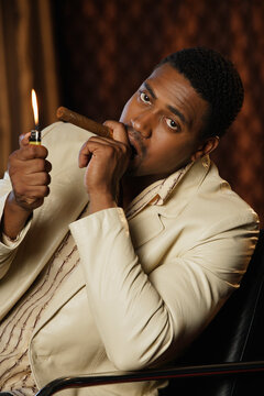 Portrait of African man lighting cigar