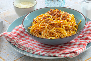 spaghetti bolognese in a blue plate