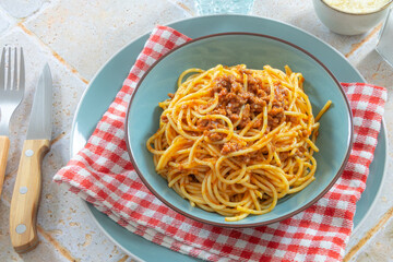 spaghetti bolognese in a blue plate