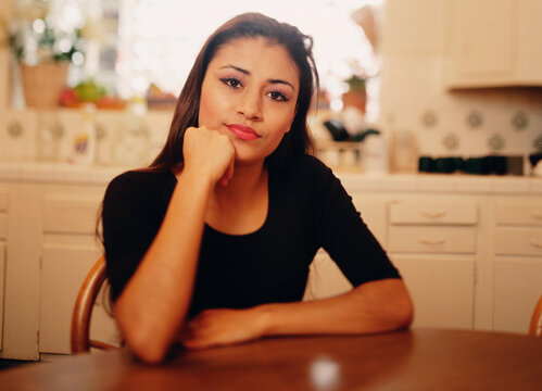 Young woman posing for the camera at dinner table