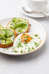 Keto Toasts with ricotta, egg, cucumber and black sesame.