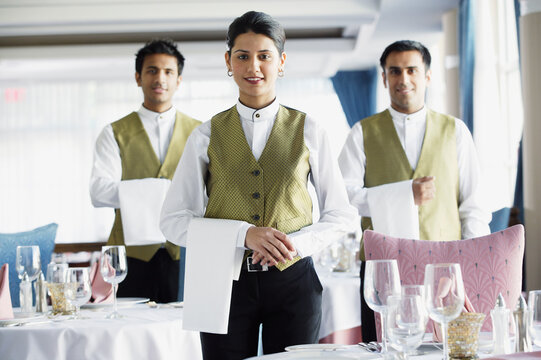 Waiters smiling for the camera in restaurant
