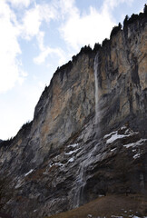Fototapeta na wymiar Staubbach waterfall during winter time in Lauterbrunnen village, Switzerland