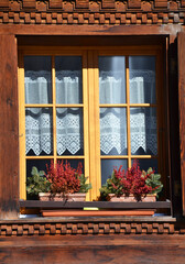 Old style open windows of a house in a swiss village