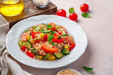 Vitamin salad with vegetables, quinoa, dill and basil on a light background.
