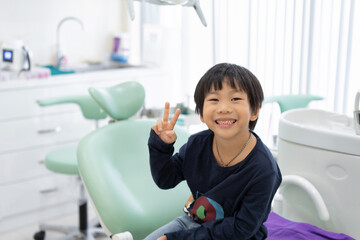 The Asian boy feel happy to sit on the dental chair in dental clinic - 490594161