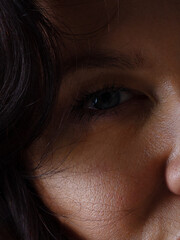 Close up of blue woman eye with beautiful brown with red and orange shades smokey eyes makeup. Modern fashion make up