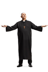 Full length portrait of a mature priest standing and raising arms