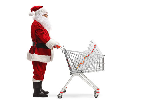 Full Length Profile Shot Of Santa Claus Standing With A Shopping Cart And A Bar Chart Inside