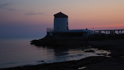 Famous landmark windmill near Molos area overlooking the Aegean deep blue sea, Skiros island, Sporades, Greece