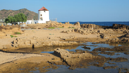 Famous landmark windmill near Molos area overlooking the Aegean deep blue sea, Skiros island, Sporades, Greece