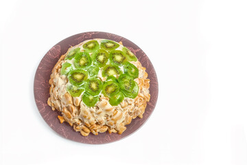 Top view of a delicious cake made from cookies, sour cream, bananas and kiwi. Cracker cake without baking.