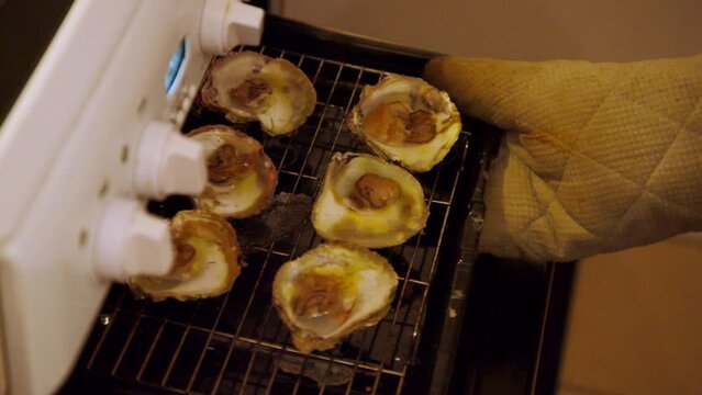 Oysters in garlic and butter coming out of the kitchen oven