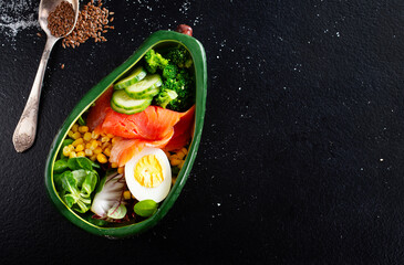 Fototapeta na wymiar bowl with avocado, salmon, couscous and poached egg