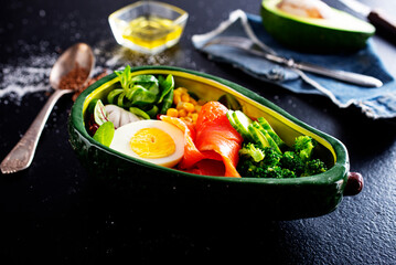 bowl with avocado, salmon, couscous and poached egg