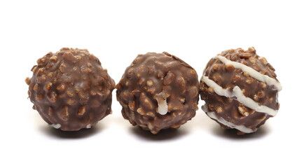Round hazelnut chocolates isolated on white  