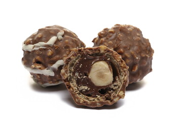 Round, half, hazelnut chocolates isolated on white  
