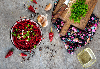 Beetroot salad with oil and nuts in white bowl. Selective focus.