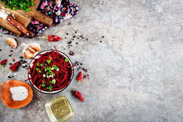 Beetroot salad with oil and nuts in white bowl. Selective focus.