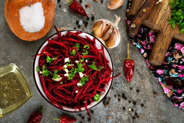 Beetroot salad with oil and nuts in white bowl. Selective focus.