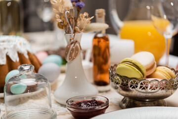 delicious macarons and fruit jam on table served for easter celebration.