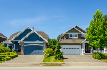 Garage door in luxury house with trees and nice landscape