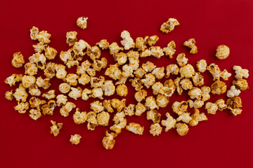 caramel popcorn on red background, sweet snacks