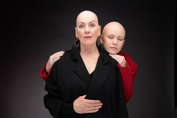 Two women with Alopecia pose together in studio.