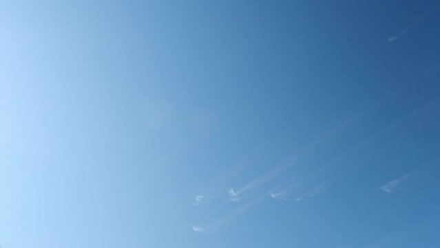 Gift box with big silver balloons flies down against clear blue sky. Airdrop of inflatable balls attached to heavy case. Low angle shot super slow motion
