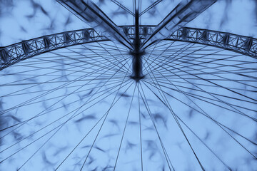 creative image based upon a photograph of the London Eye attraction viewed from an unusual point of view - obrazy, fototapety, plakaty