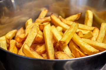 French fries in metal bowl close up image.