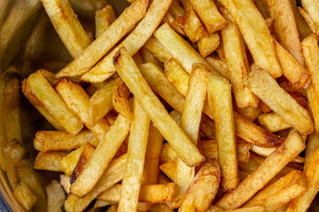 Crispy French fries background closes up image.