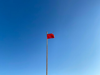Lifeguard flag on the beach , red flag