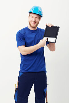 Digital technology makes construction easy. Portrait of a happy young man showing you a digital tablet.