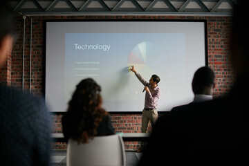Presenting key notes to his colleagues. Shot of a businessman giving a presentation to his colleagues.