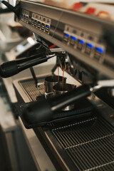 The process of making espresso in a coffee machine. Barista prepares a cappuccino togo