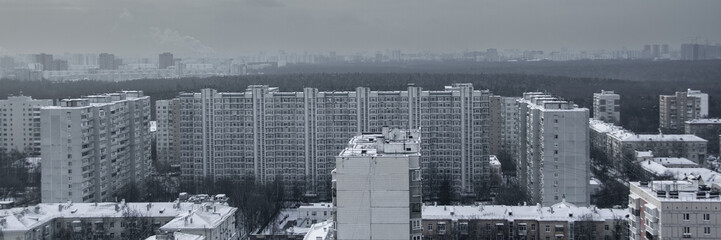 Rooftops and high residential buildings covered by snow in winter