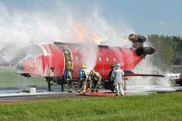 Firefighters attacking aircraft fire in training