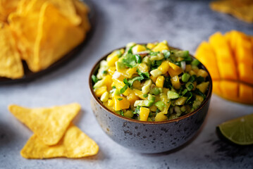 Mango Guacamole with corn chips and ingredients to prepare it