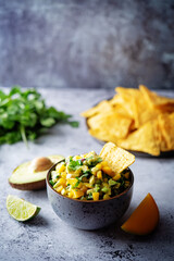 Mango Guacamole with corn chips and ingredients to prepare it