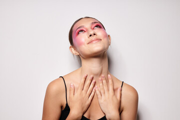 fashionable woman pink face makeup posing attractive look light background unaltered