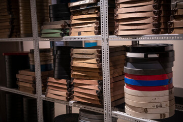 Film reels for old vintage cinema movie projector in video library.
